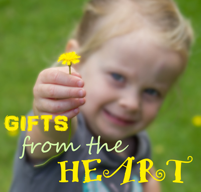 Gifts from the Heart - toddler holding out a dandelion